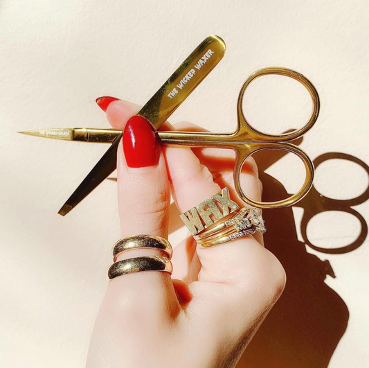 Beauty Tools Being Held inbetween fingers
